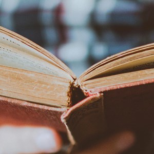 A close up of someone holding a book open.